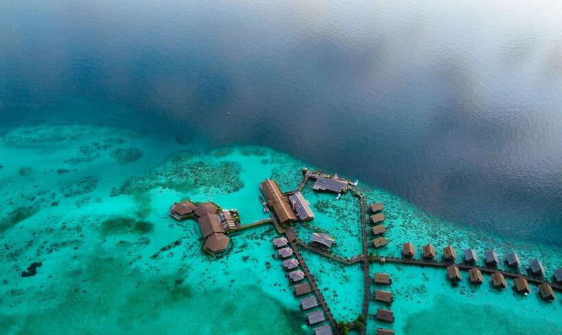 Semporna: Mabul and Kapalai Trip in Snorkel or Dive & Lunch - Mabul Water Bungalows and the village shoreline
